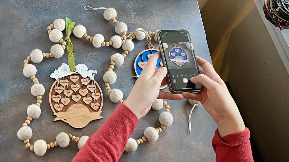 person photographing their products